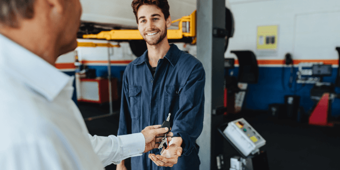 Man Happily Dropping Car off at Auto Repair Shop